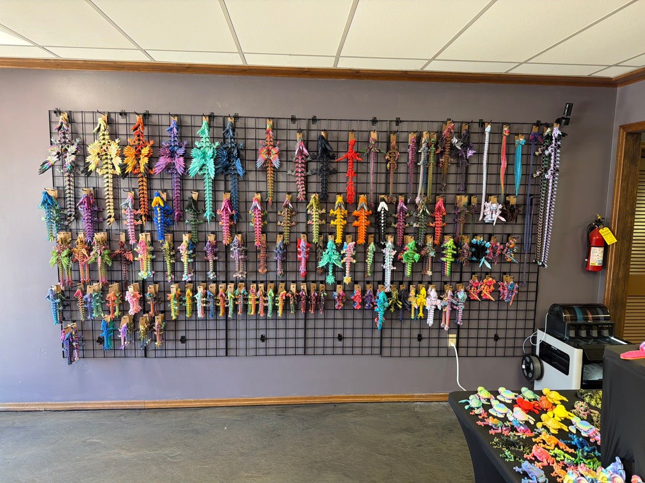 Colorful 3D printed collectibles displayed on the wall at Heartland Craft LLC